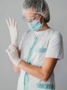 doctor-putting-surgical-gloves_23-2148847215